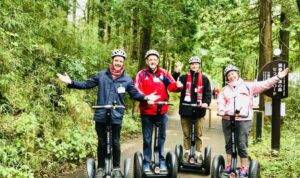 4 people riding segways